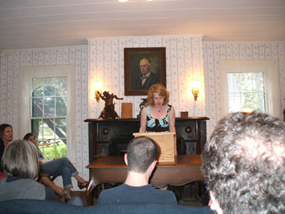 Tracy Strauss reads in the Blue Parlor.
