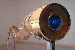 Deb Todd Wheeler, LUDICRUM: NATURALIA, ARTIFICIALIA, SCIENTIFICA – V.5 (2002), brass, steel, LCD screen, video, 78 in. x 28 in. x 60 in.