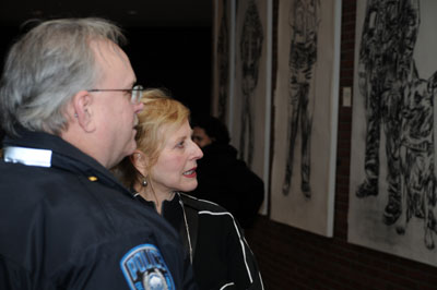 Artist Mira Cantor talking to one of the Boston police officers about the work.