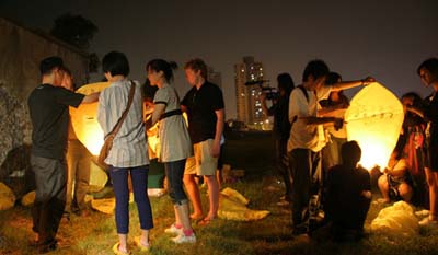 Artists prepare to launch Kongming lanterns, Here Comes the Sun, Zendai MoMA, Shanghai, China