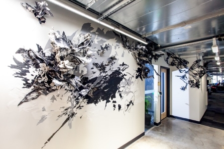 Debra Weisberg creates a drawing installation at the Facebook Cambridge Office. Photo by Simone Scheiss.