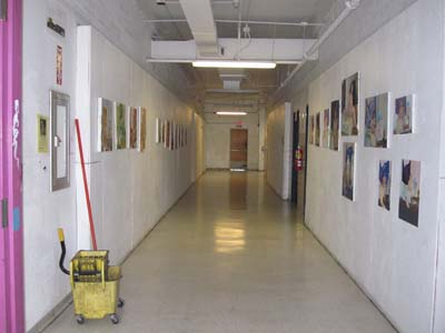 A clean hallway, with hanging artwork. Photograph by ArtSake.