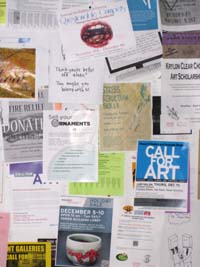 Flyers pinned to a wall with pushpins. Photograph by ArtSake.