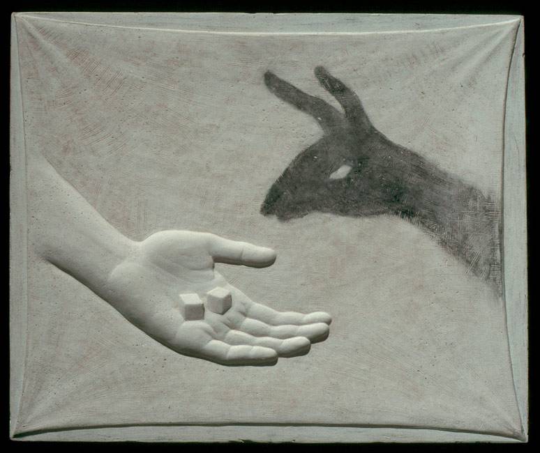Art combining sculpture and drawing with a relief sculpture of a hand "feeding" sugar cubes to a drawing of a shadow puppet animal.