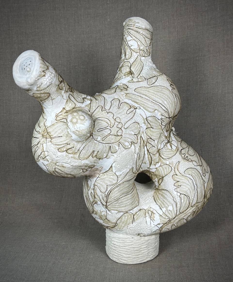 An abstract sculpture incorporating paper clay and antique lace.