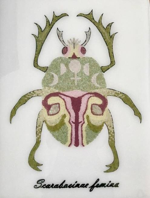 Paper and resin artwork of a light green beetle with a shell pattern resembling a female reproductive system.